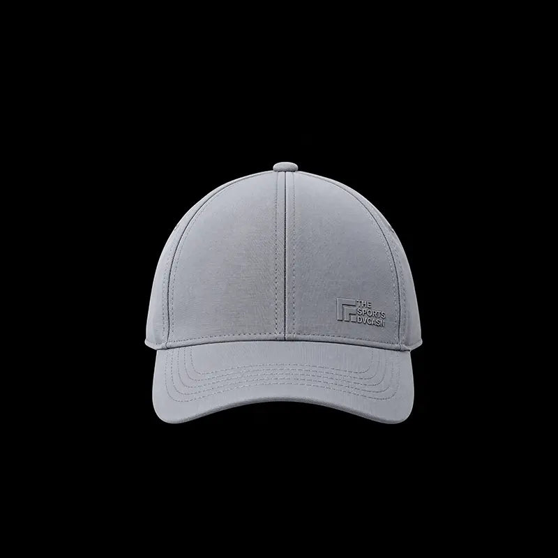 Grey six-panel baseball cap, front view with curved brim and embossed logo patch