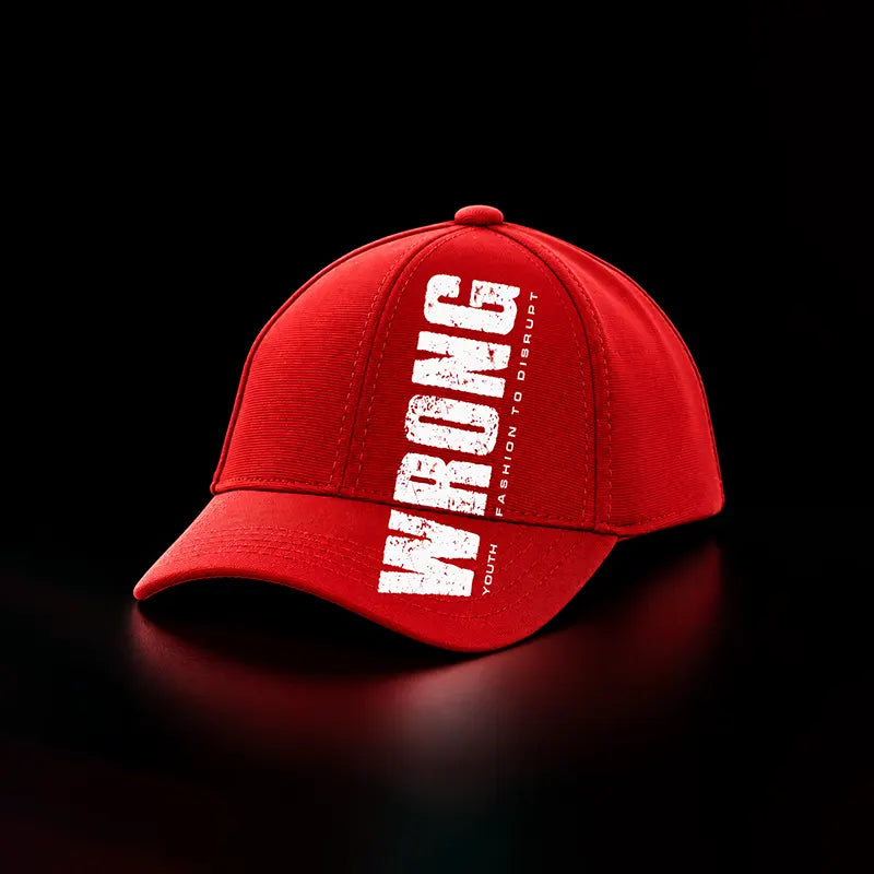 A red baseball cap with distressed white text reading 'WRONG' vertically on the front, plus smaller text 'DESIGN TO DISTURB' and 'YOUTH' on a black background.