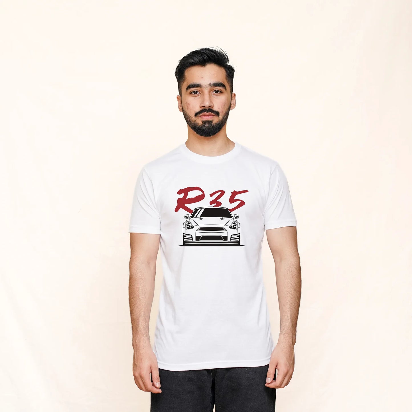 A man wearing a white crew neck T-shirt with a graphic print of a Nissan R35 and the text 'R35' on the front.